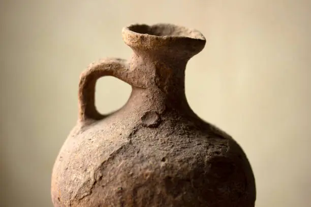 antique, earthen water pot, on color background