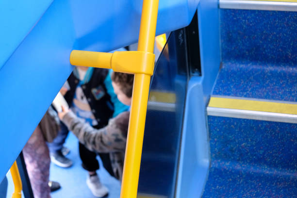 a family boarding a london bus with their mother, as seen from top deck - bus family travel destinations women imagens e fotografias de stock