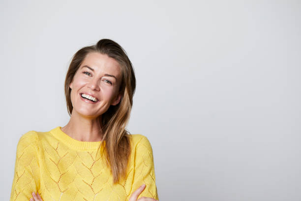 istock Smiling woman in yellow 1163683031