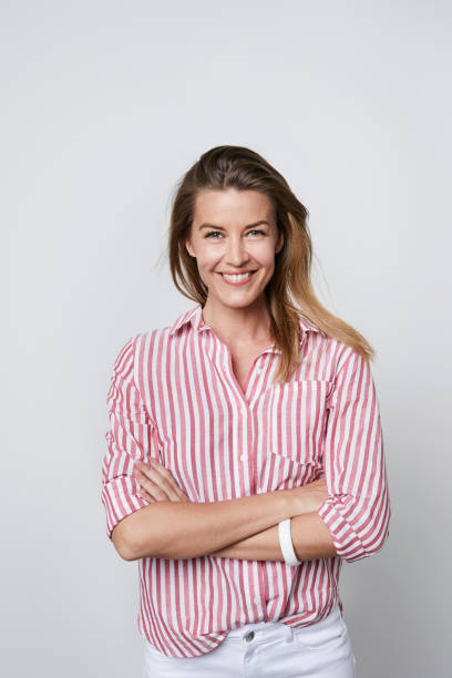 Woman smiling striped shirt Woman smiling striped shirt with arms folded, portrait 35 39 years stock pictures, royalty-free photos & images