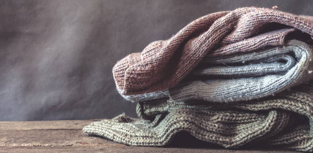 istock Knitted from a gray yarn sweater and thread for knitting closeup. Knitting as a hobby. Accessories for knitting. 1163683248