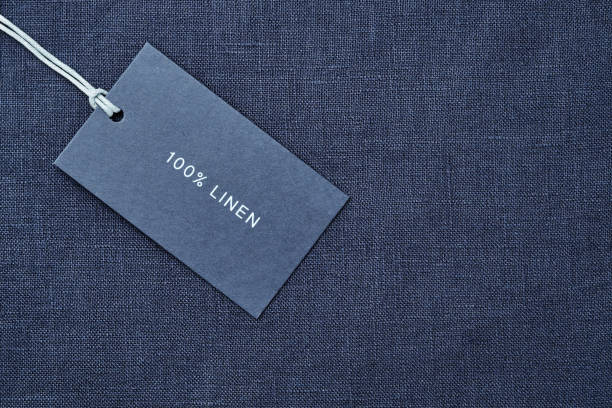 istock Label with composition of fabric on cloth background. 100% linen 1163684327