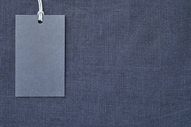 istock Blank paper label on blue linen clothes background 1163684331
