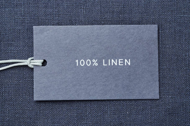 istock Label with composition of fabric on cloth background. 100% linen 1163684359