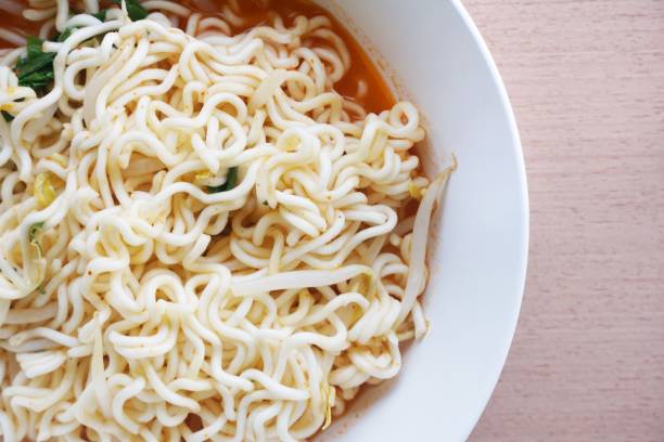 istock dry tomyum noodle on wooden table 1163685014