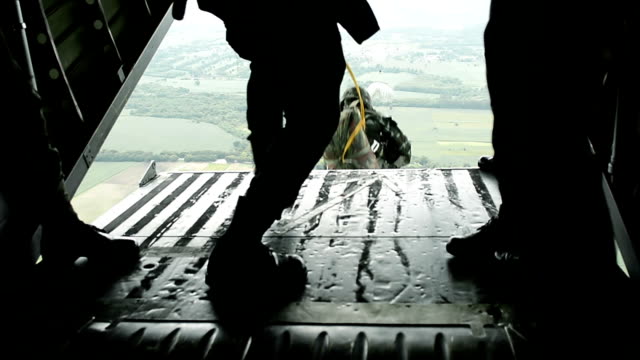 Close Up Of Army Soldiers Making A Parachute Jump From Military Transport Aircraft