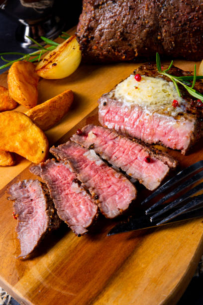 istock rustic medium butter beef steak with herbs and potato wedges 1163690665