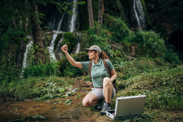 istock Woman biologist taking a water sample in nature 1163691950