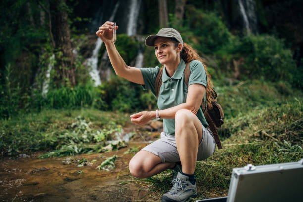 istock Lady biologist taking a water sample in nature 1163691955
