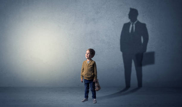 istock Little boy with businessman shadow 1163692310