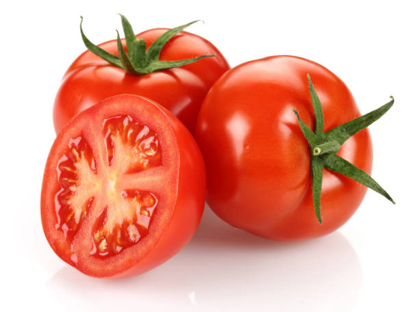 istock Half and whole fresh tomatoes isolated on white 1163694255