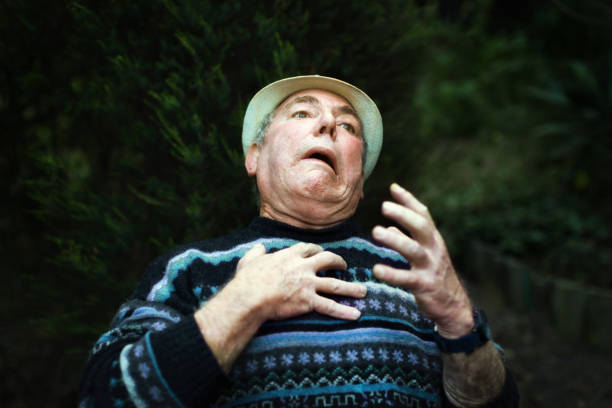 Man in Halloween wizard robes standing while holding lighting circle in the middle of the woods