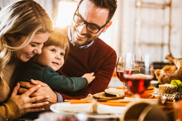 istock Young loving family enjoying in their time at dining table. 1163694629