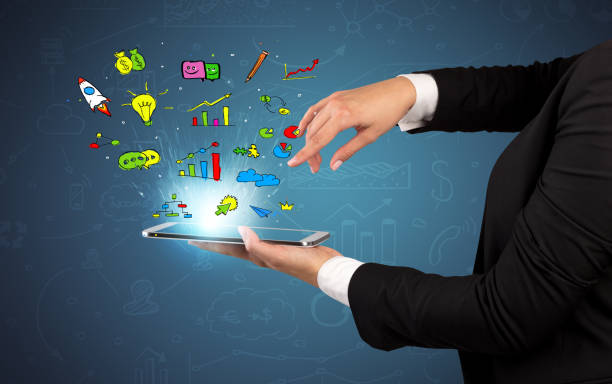 istock Holding tablet with a flying business doodles 1163694769