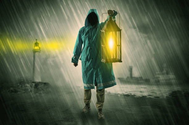 istock Man coming with lantern at coast concept 1163696208