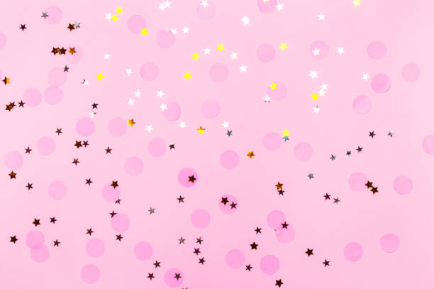 istock Pink confetti and stars and sparkles on pink background. 1163697684