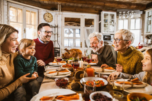 istock Happy extended family talking during Thanksgiving meal at dining table. 1163699224