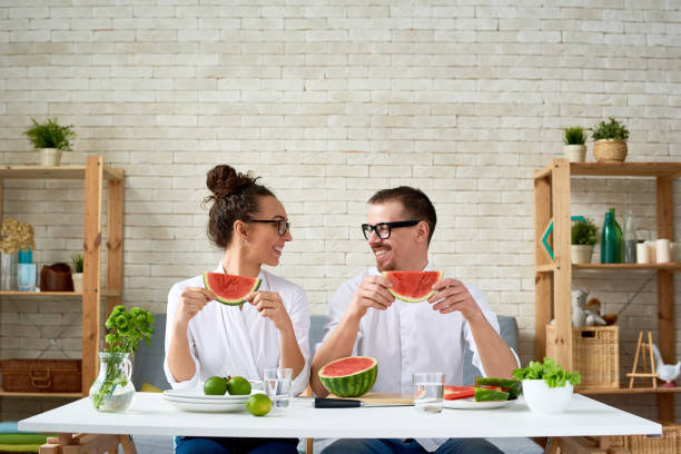 istock Happy vegan couple with watermelon slices 1163700134