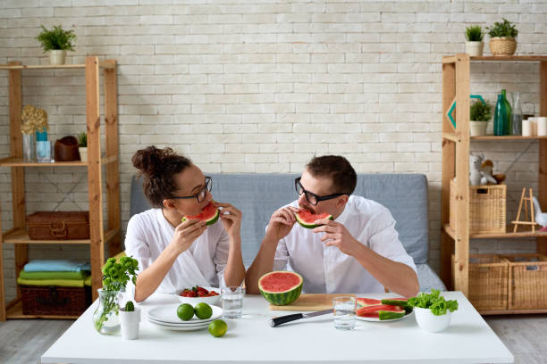 istock Young vegan couple eating watermelon 1163700136