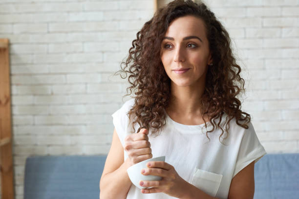 istock Young woman pounding spices in mortar 1163700178