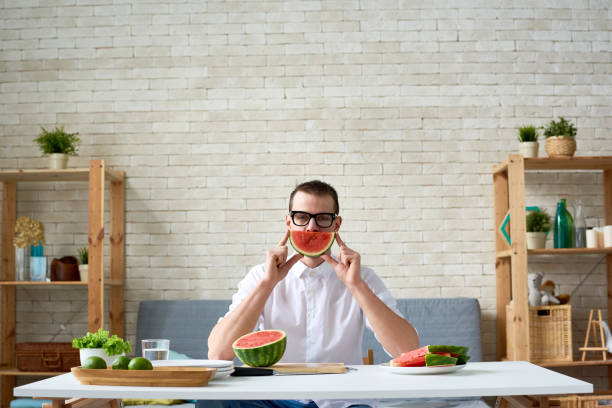 istock Vegetarian man with slice of watermelon 1163700255