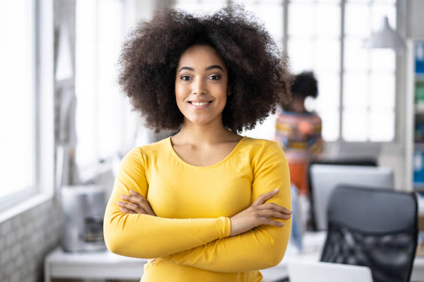 istock African woman in yellow outfit leaning on table 1163701352