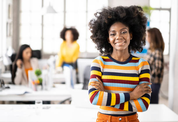 istock African woman standing arms crossed and looking at camera 1163701355