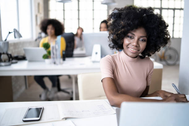 istock Thoughtful african woman sitting in modern workplace 1163701363