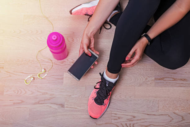 istock Woman checking her smartphone before running or other sport 1163701688