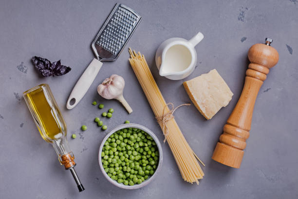 istock Ingredients for making spaghetti with cream and peas on the grey background, 1163703097