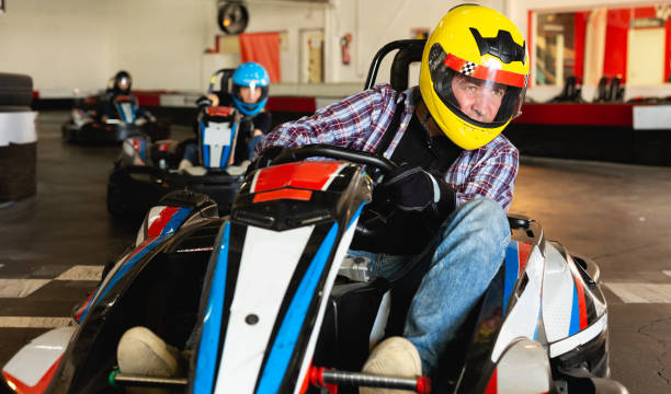 istock Man driving go-kart car 1163703241