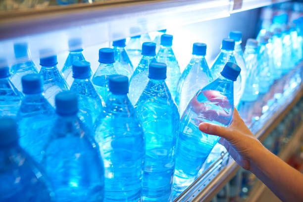 istock Crop person taking bottle from shelf 1163704021