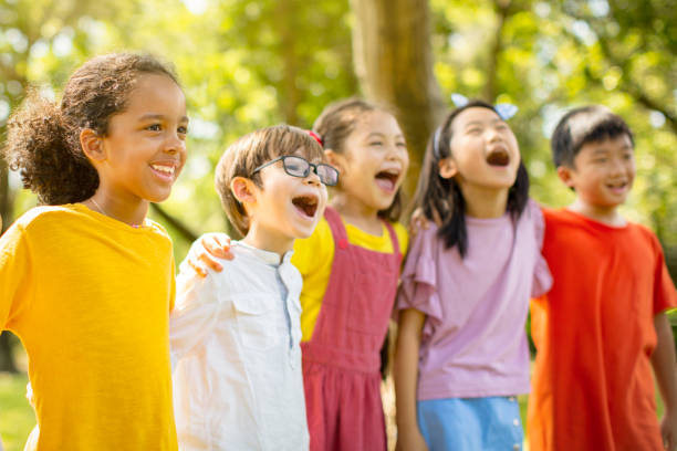 istock Multi-ethnic group of school kids laughing and embracing 1163704874