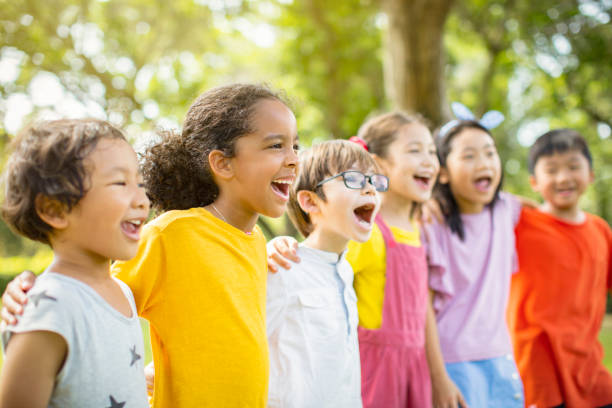 istock Multi-ethnic group of school kids laughing and embracing 1163704875