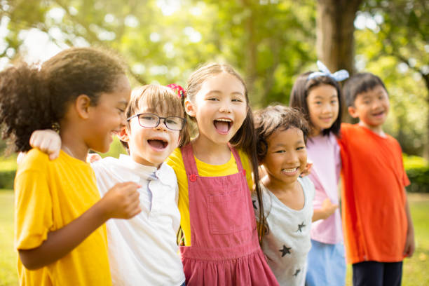 istock Multi-ethnic group of school children laughing and embracing 1163704876