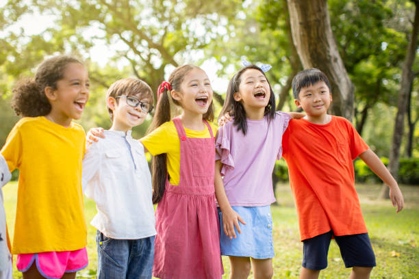 istock Multi-ethnic group of school kids laughing and embracing 1163704877