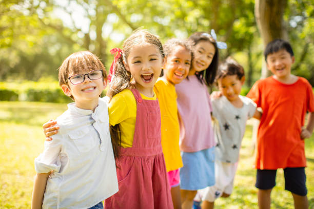 istock Multi-ethnic group of school children laughing and embracing 1163704898
