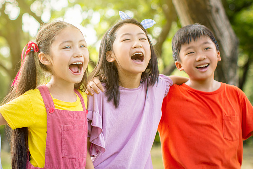 Multi-ethnic group of school kids laughing and embracing