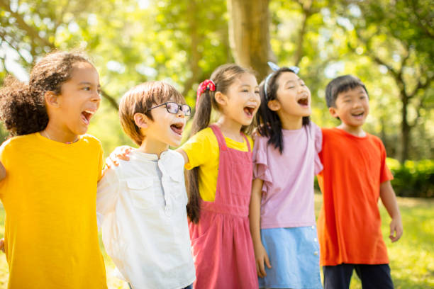 istock Multi-ethnic group of school children laughing and embracing 1163704900