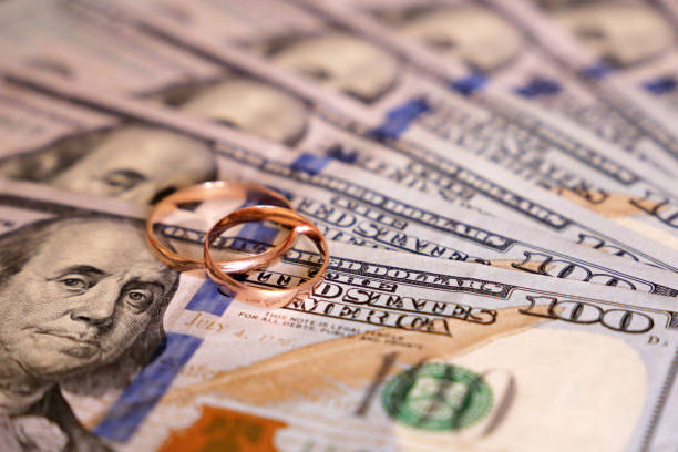istock Wedding rings on US dollars 1163705955