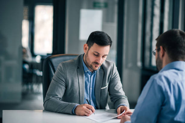 istock Elegant man signing document, contract with manager. 1163706253