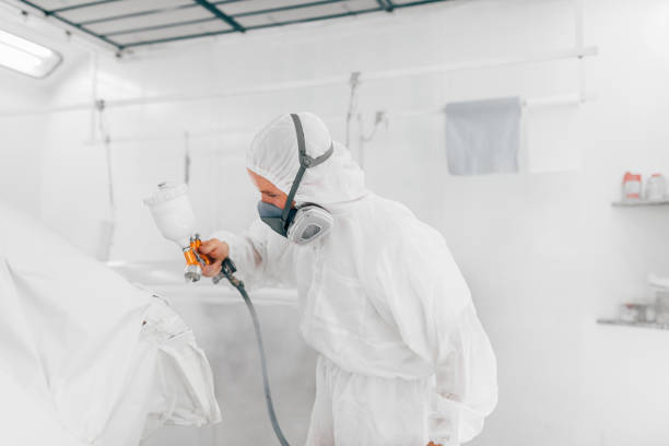 istock Automotive industry concept. Worker painting car with compressor. 1163706934