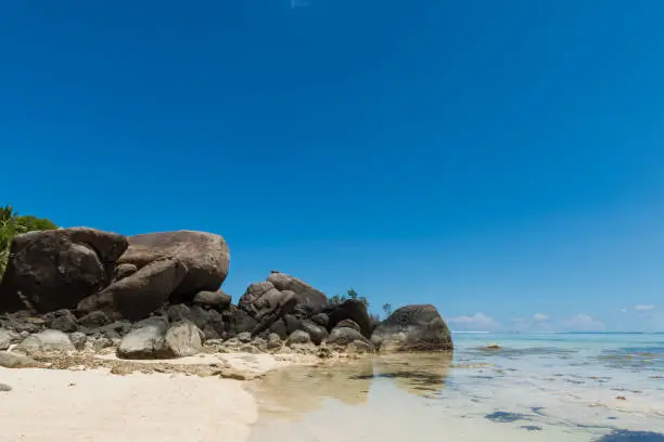 Photo of Big rocks on sandy Seychelles beach landscape