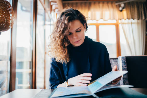istock Young woman looking carefully at menu 1163708727