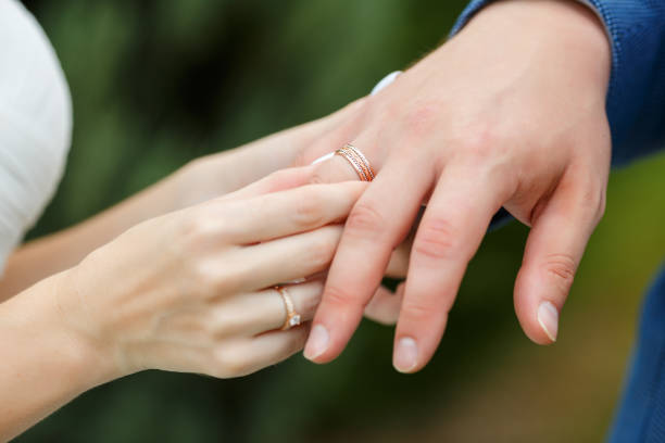 istock Newlyweds put each other rings on the ceremony 1163708765