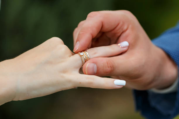 istock Newlyweds put each other rings on the ceremony 1163708784