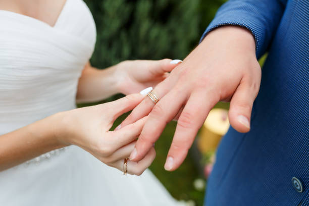 istock Newlyweds put each other rings on the ceremony 1163708800