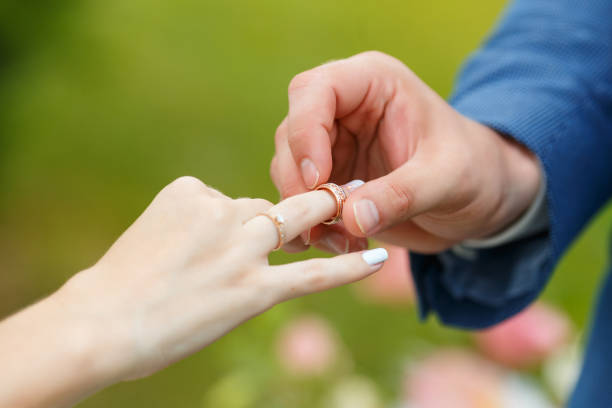 istock Newlyweds put each other rings on the ceremony 1163708802