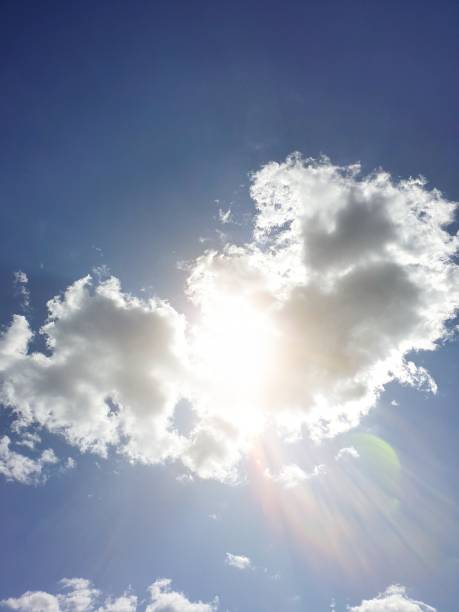 istock the sun shines through the clouds against the blue sky 1163710235