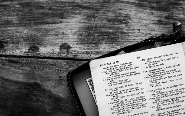 istock Holy Bible isolated on old vintage wooden table 1163712112